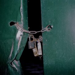 padlock on chain closing the metal door