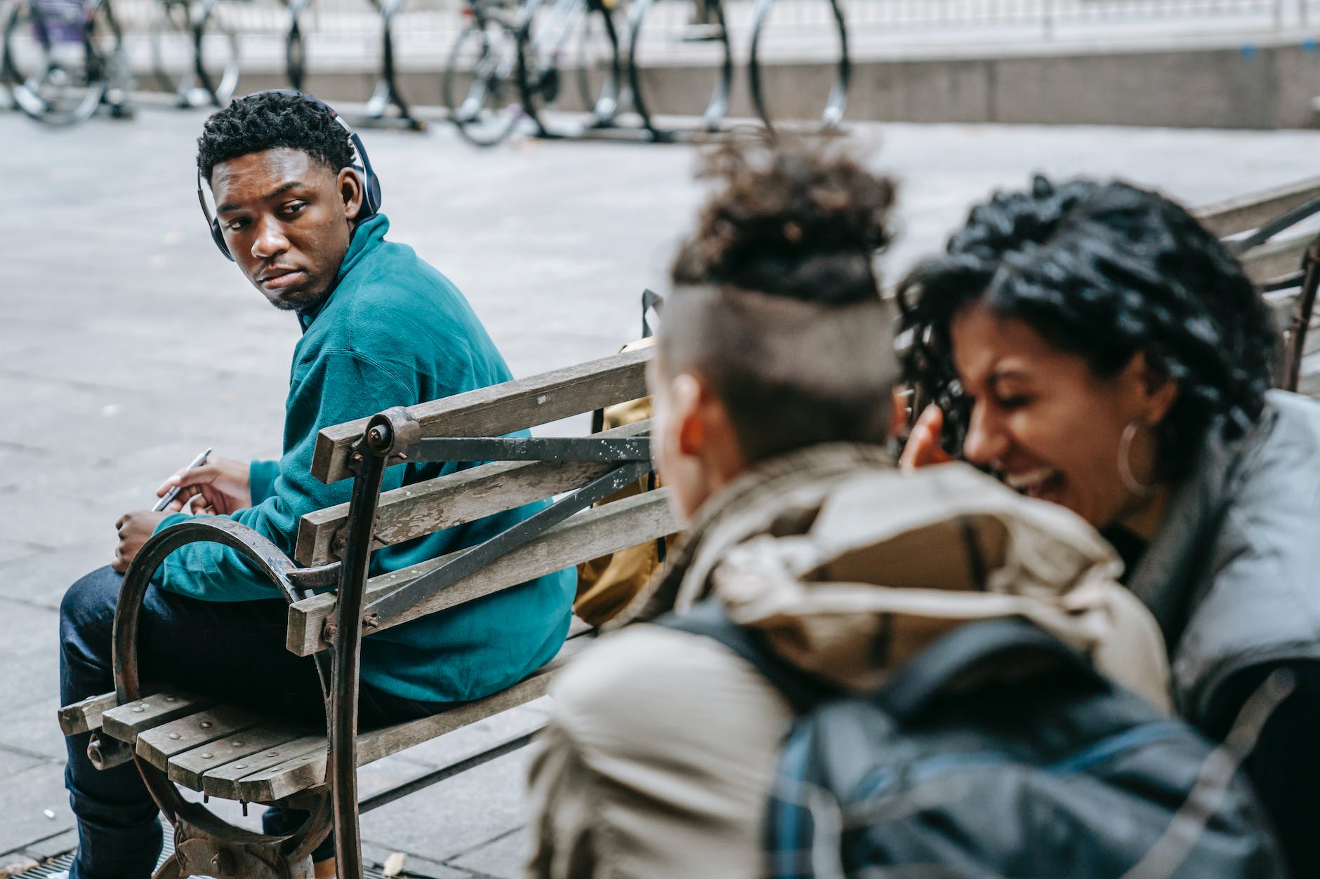 couple of students gossiping and laughing near black man