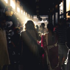 people waking between brown wooden stands during daytime